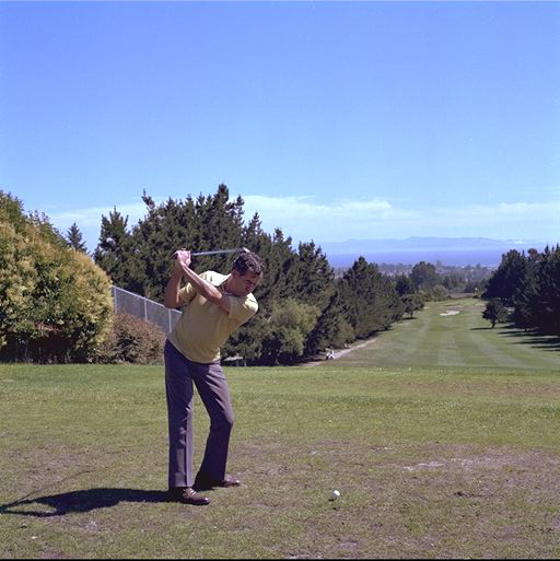 Golfer executing a drive swing showing proper technique