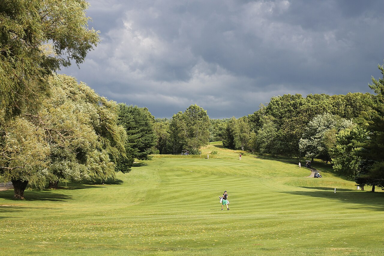Golf course on a cloudy rainy day with dark clouds in the sky