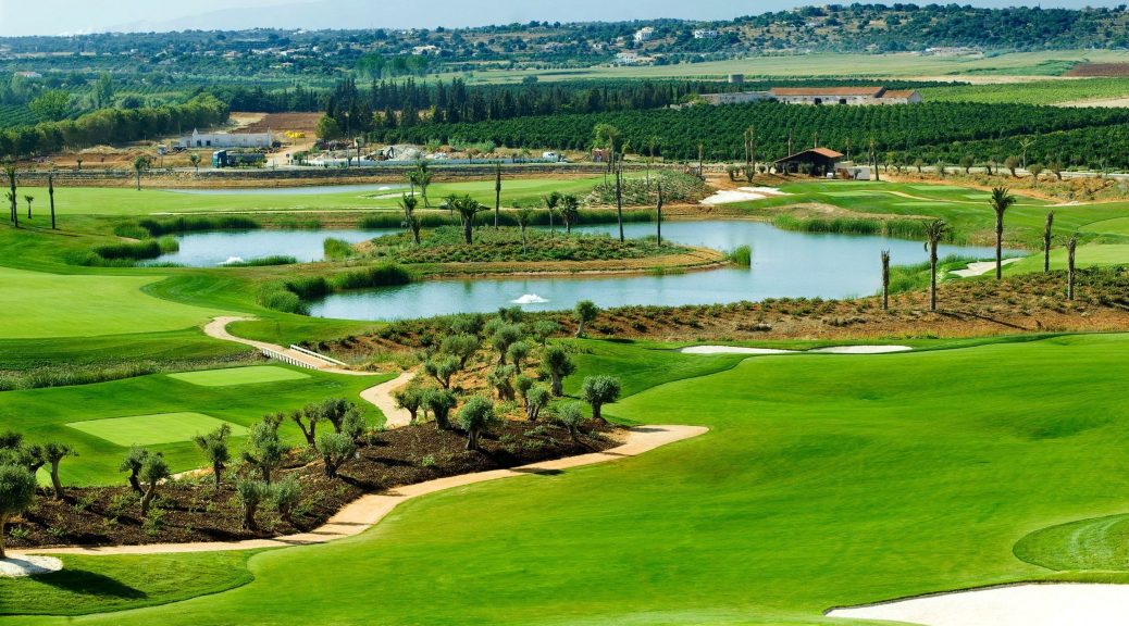 Aerial view of a scenic golf course with bunkers and water hazards