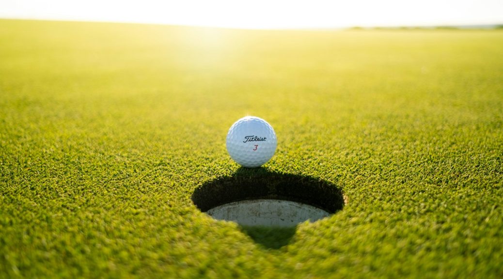 Golf ball on putting green - best golf putters under $200