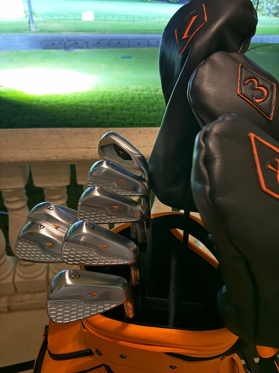 Close-up of McLaren Golf irons in Justin Rose's bag showing honeycomb cavity detailing and papaya logos